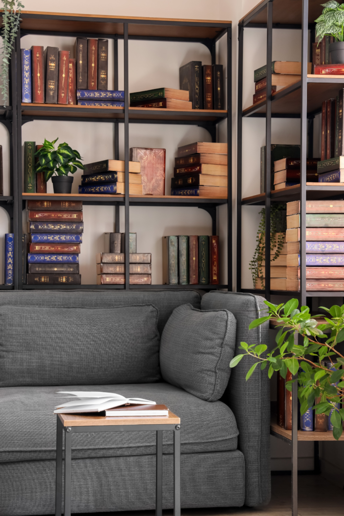 Stack of decorative coffee table books styled with a candle and small decor items, perfect for modern, minimalist, and budget-friendly living room decor.