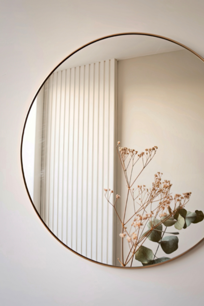 Large wall mirror brightening and adding depth to a spring living room refresh.