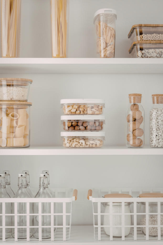 Stackable pantry storage bins neatly organizing snacks, cereals, and dry goods in kitchen