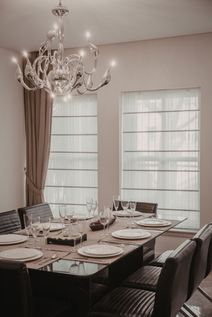 Elegant statement chandelier above dining table adding a focal point to modern dining room decor 
