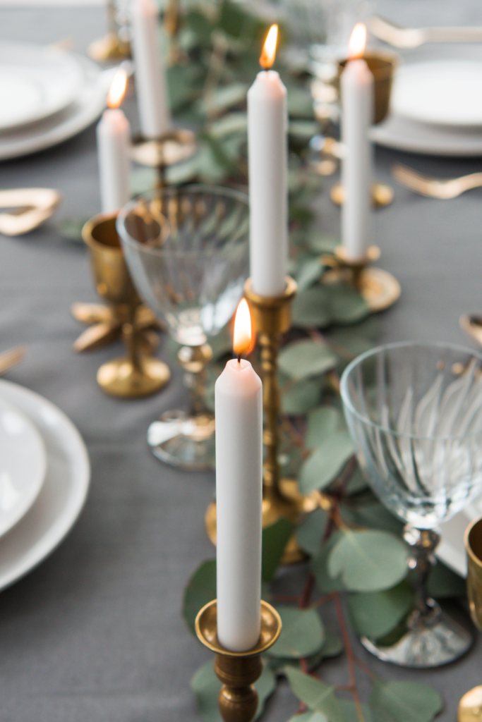 Tabletop candle centerpiece on dining table adding warmth and style to dining room space