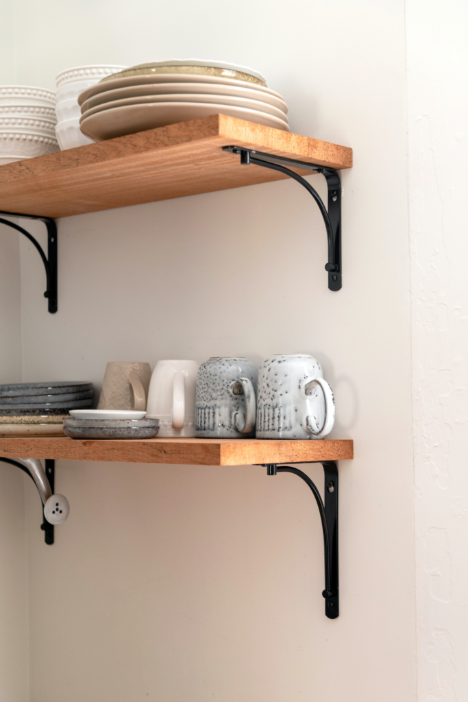 Wall mounted shelves in dining room displaying decor