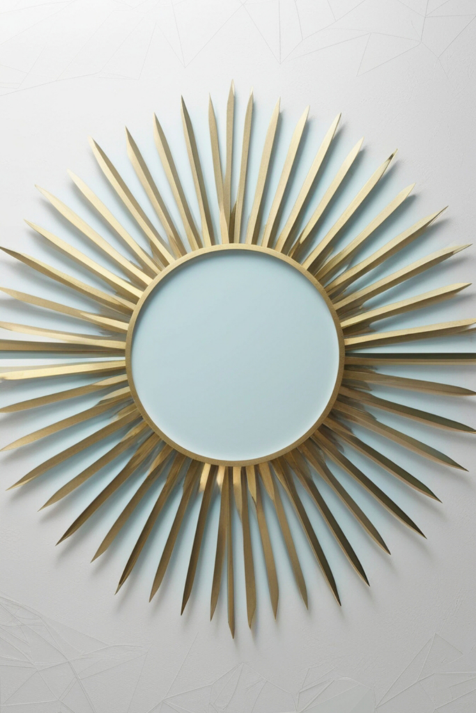 large gold sunburst wall mirror with spiked metal frame on white textured wall